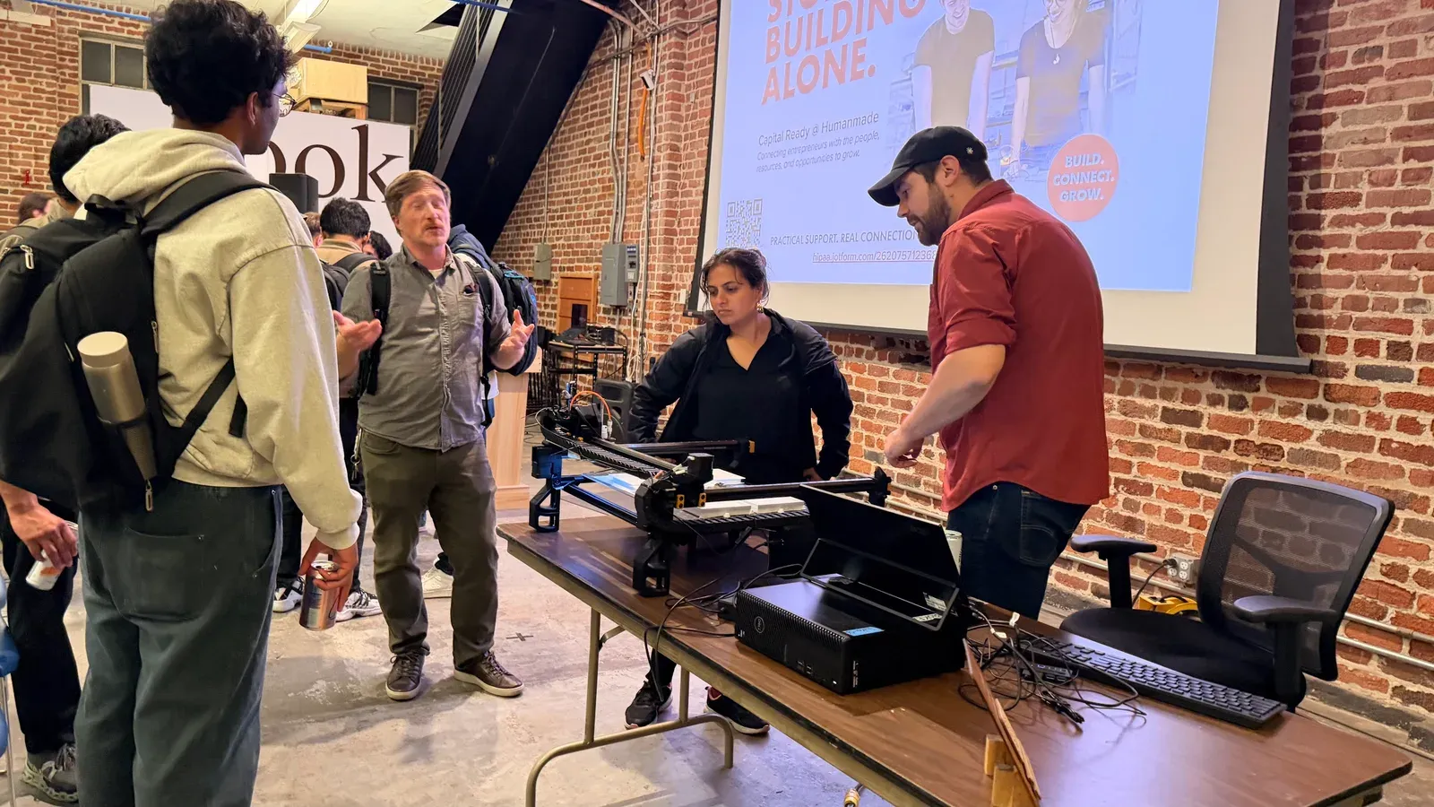 Scientists discussing BioKEA’s automated insect sorter at Science Demo Night at Humanmade