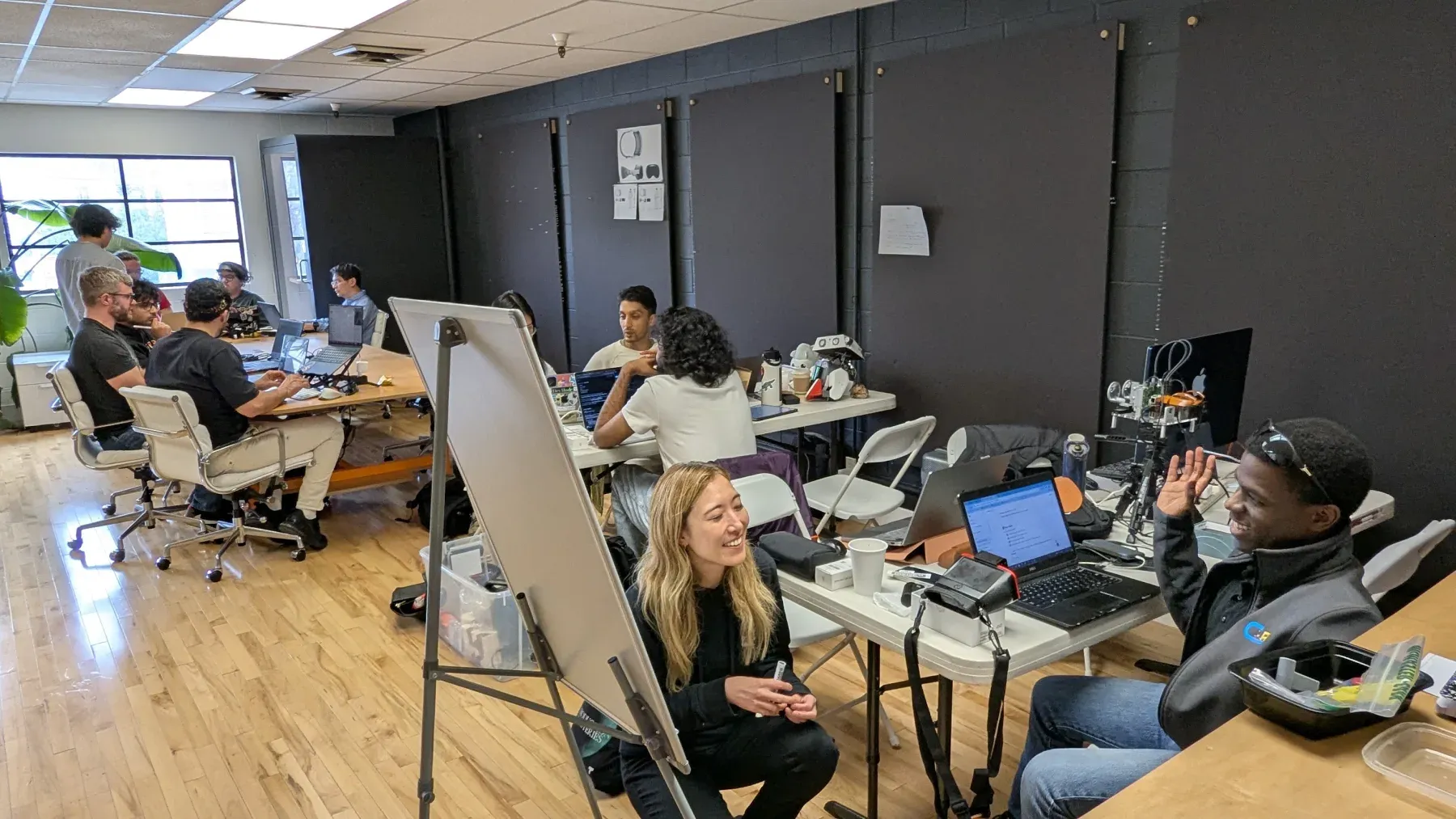 Builders working with open-source robotics at a Worldwide Studios session