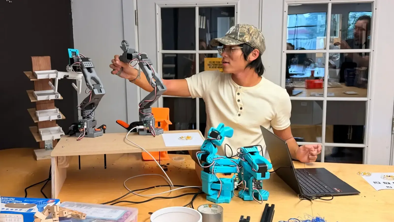 A builder testing an SO-101 arm with printed parts
