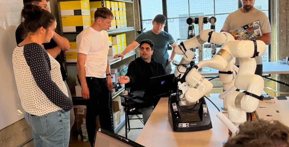 Builders working beside robotic arms